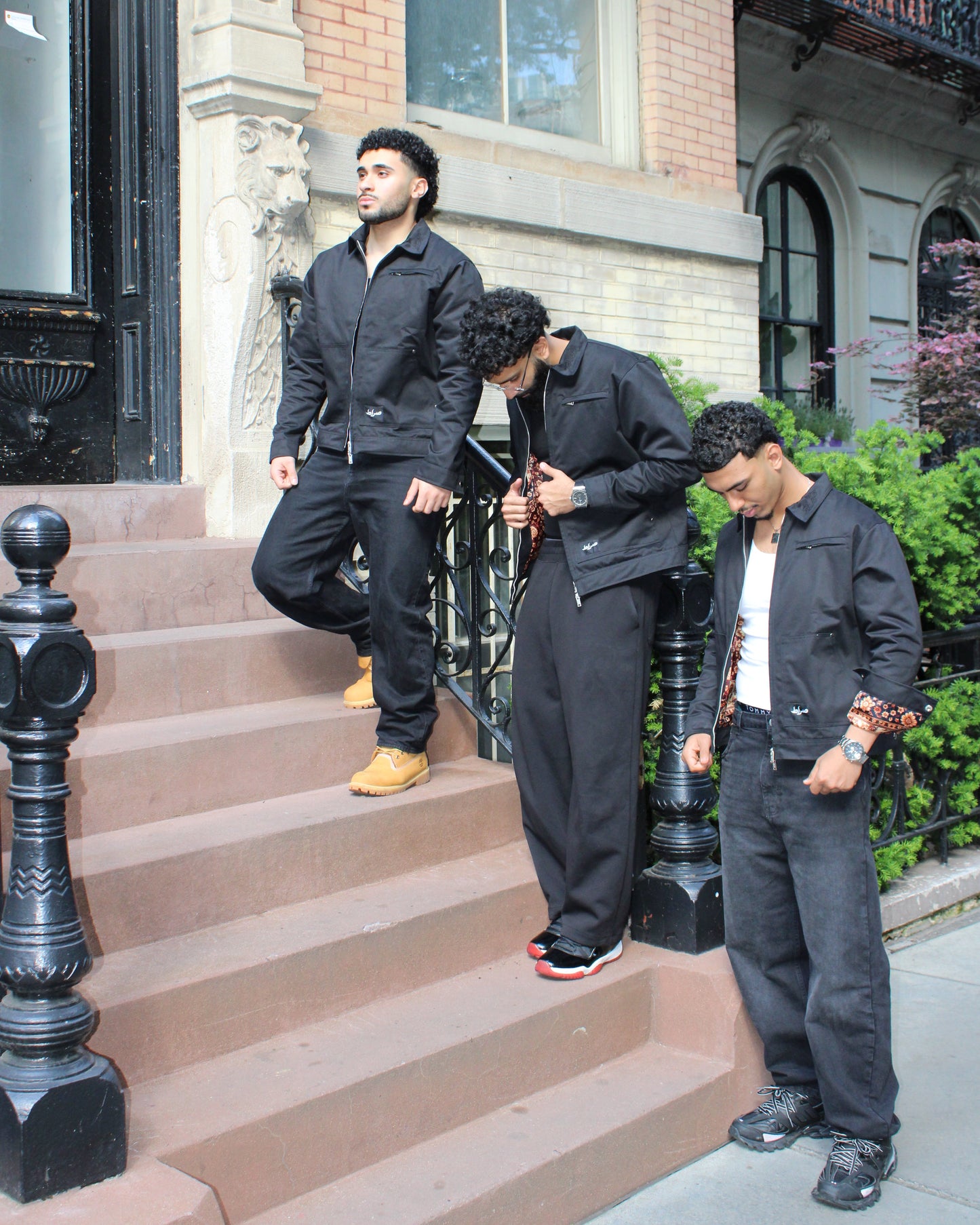 Three men standing on a set of stairs in an urban setting